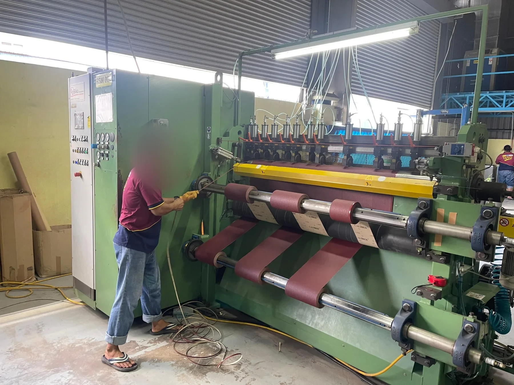 Coated abrasive material being cut to required dimensions