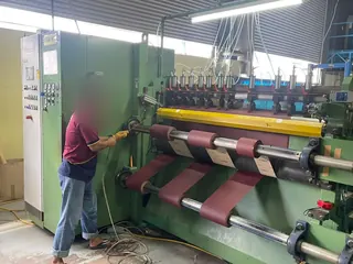 Close view of coated abrasive material being cut for conversion
