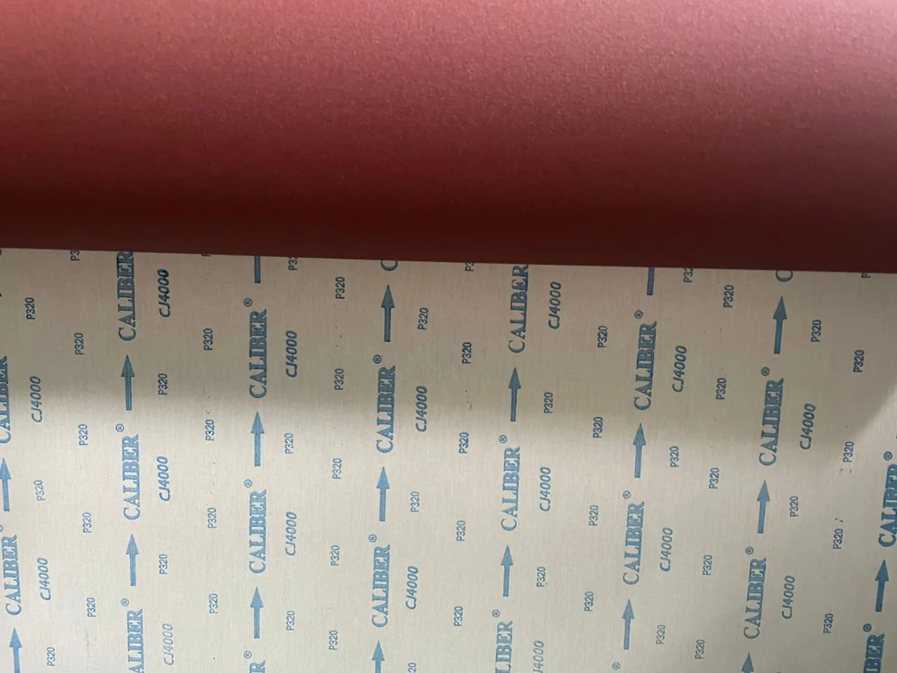 CALIBER CJ 4000 abrasive sample showing the abrasive face and cloth backing