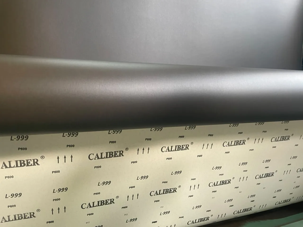 CALIBER L-999 abrasive sample showing the abrasive face and cloth backing