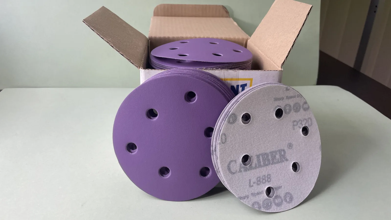 Five-inch L-888 Velcro sanding discs with six dust-extraction holes
